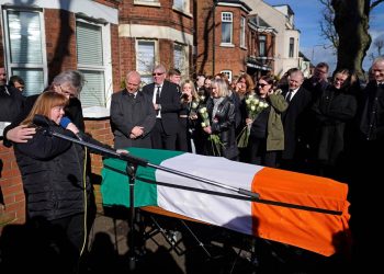 Brendan 'Bik' McFarlane's wife Lene and daughter Tina speaking next to his coffin before it leaves his family home on Cliftonville Road, Belfast.