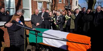 Brendan 'Bik' McFarlane's wife Lene and daughter Tina speaking next to his coffin before it leaves his family home on Cliftonville Road, Belfast.