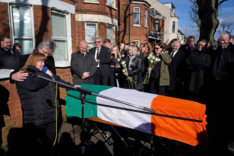 Brendan 'Bik' McFarlane's wife Lene and daughter Tina speaking next to his coffin before it leaves his family home on Cliftonville Road, Belfast.