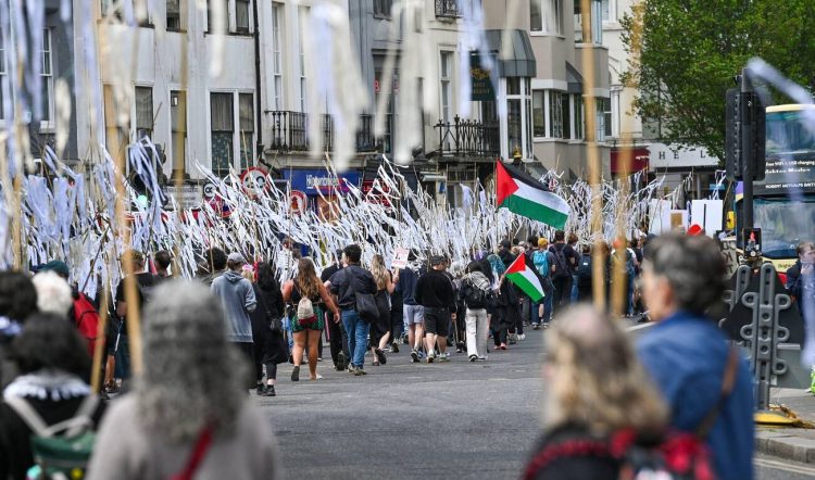 Brighton UK 18th May 2025. Over a thousand marchers took to the streets some carrying white ribbons bearing the names of children killed in the recent conflict