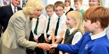 The Duchess of Cornwall meets school children as she visits Ballyhackamore Credit Union in Belfast, Northern Ireland, as the Prince of Wales and Camilla, attend a series of engagements in Northern Ireland following their two day visit in the Republic of Ireland.
