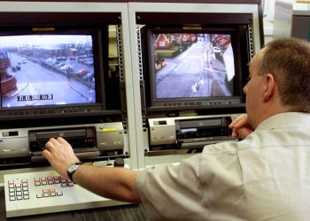 A Police Service of Northern Ireland CCTV controller operates some of the new cameras which have been installed in north Belfast, Northern Ireland, Thursday, Feb. 28, 2002.