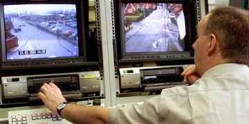 A Police Service of Northern Ireland CCTV controller operates some of the new cameras which have been installed in north Belfast, Northern Ireland, Thursday, Feb. 28, 2002.