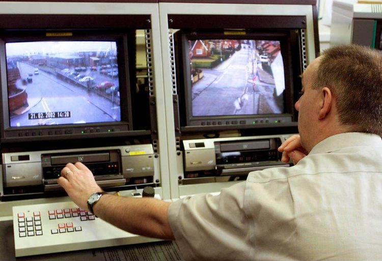 A Police Service of Northern Ireland CCTV controller operates some of the new cameras which have been installed in north Belfast, Northern Ireland, Thursday, Feb. 28, 2002.