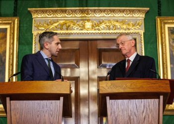 Northern Ireland Secretary Hilary Benn (right) and Tanaiste Simon Harris (left) speak to the media in the Throne Room at Hillsborough Castle, Belfast, following the publication of a new joint framework to deal with the legacy of the NI Troubles.