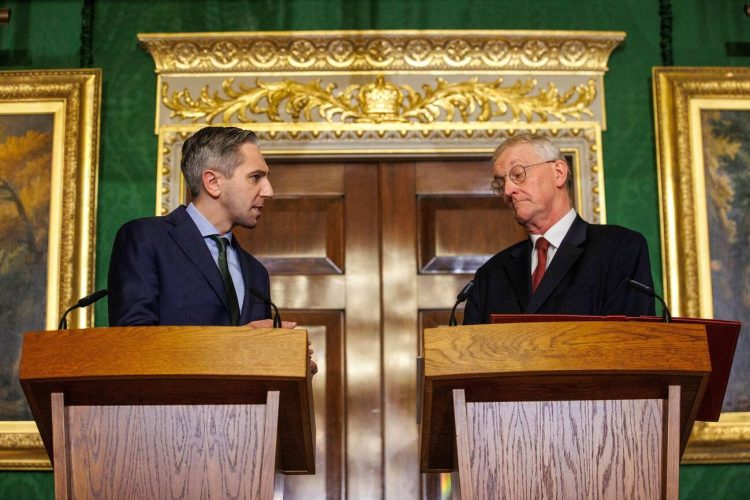 Northern Ireland Secretary Hilary Benn (right) and Tanaiste Simon Harris (left) speak to the media in the Throne Room at Hillsborough Castle, Belfast, following the publication of a new joint framework to deal with the legacy of the NI Troubles.